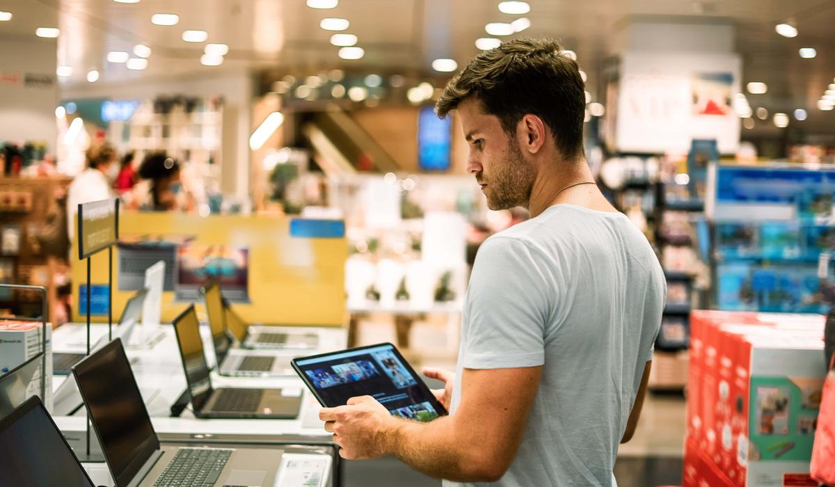 Client choosing laptop in store