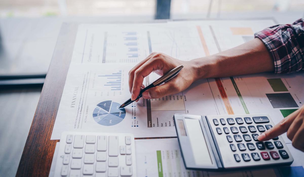 close up of businessman working on calculator to calculate business data the financial report. business financial analysis and strategy concept