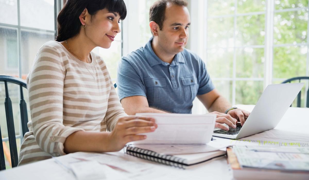 couple using laptop to pay bills