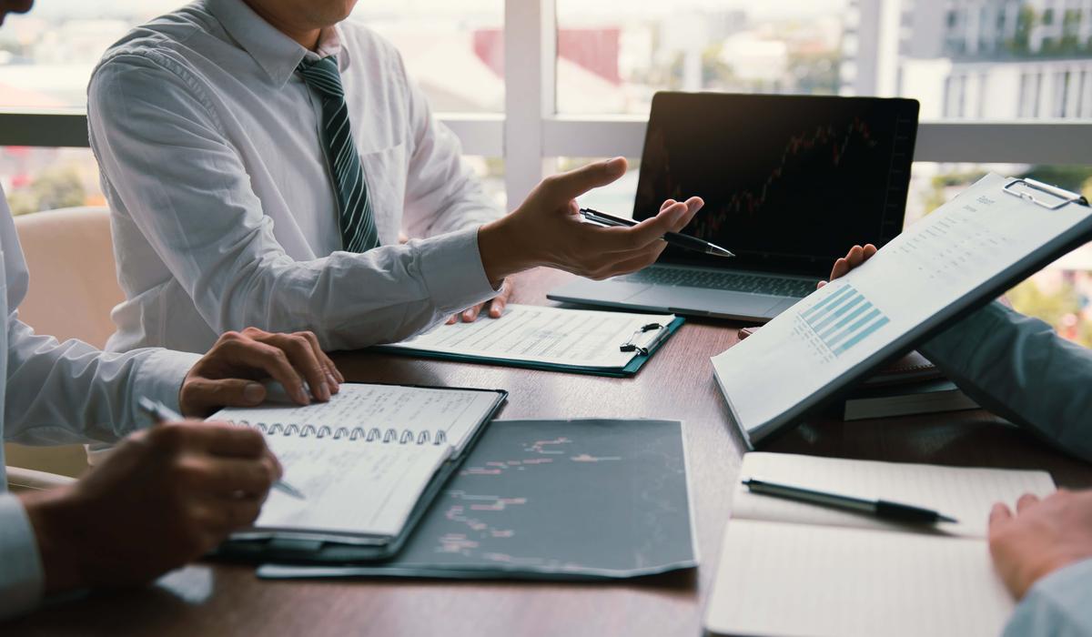 partner colleagues are talking about the results in the document on hand and together analyze the work data about the companys financial statements