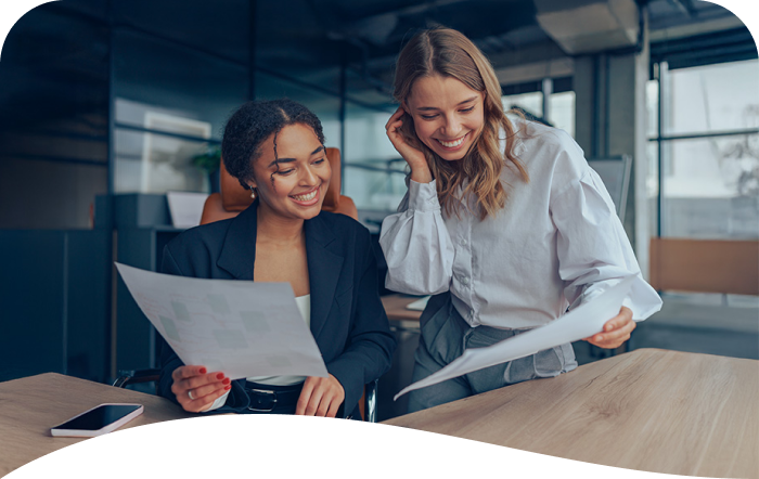 two female business owners looking at spreadsheets