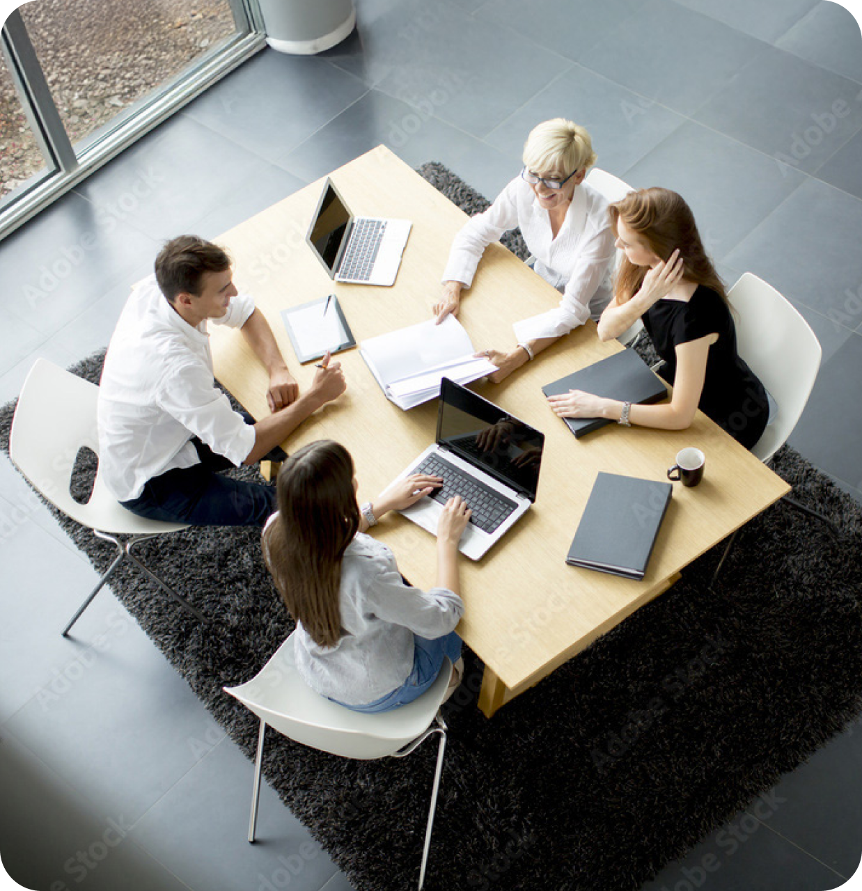 group of business people sitting around a table talking