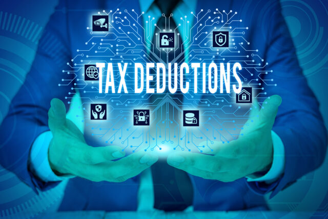 Text sign showing Tax Deductions. Business photo showcasing an amount or cost that subtracted from someone s is income Male human wear formal work suit presenting presentation using smart device