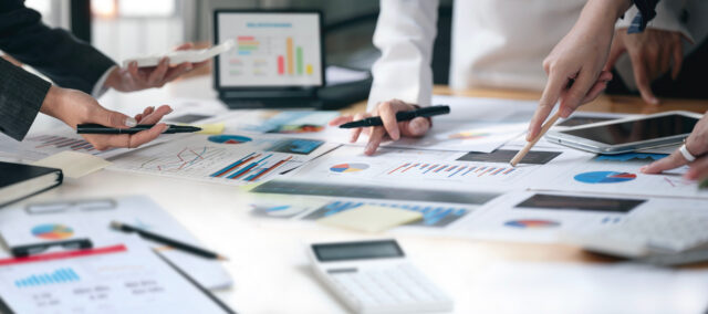 Cropped shot of diverse coworkers working together in boardroom, brainstorming, discussing and analyzing business strategy.